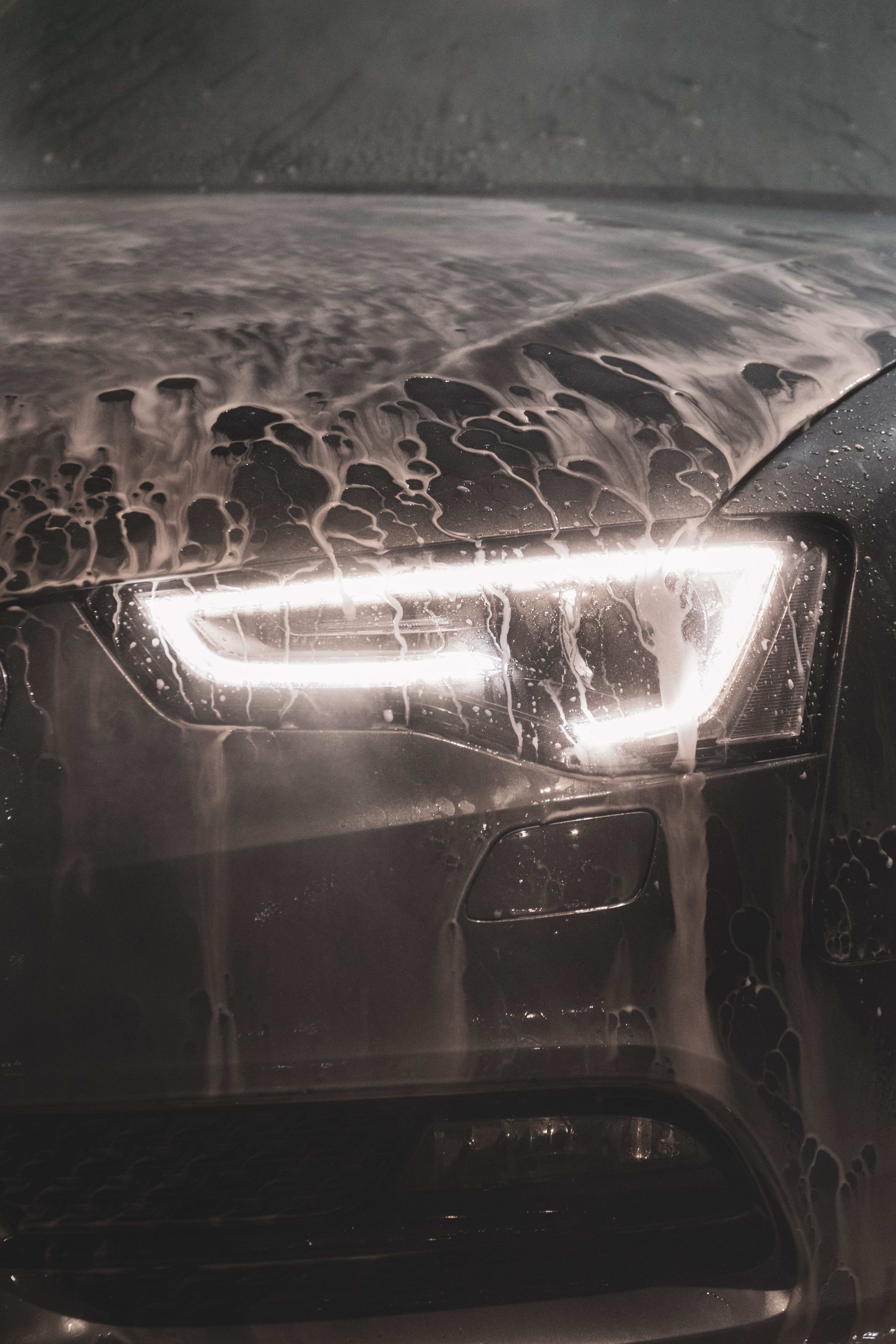 Foam rinse across a polished headlight